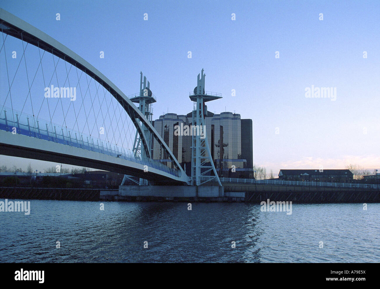 The Lowry (Lifting) Footbridge and Quay West Offices (evening), Salford Quays, Salford, England Stock Photo