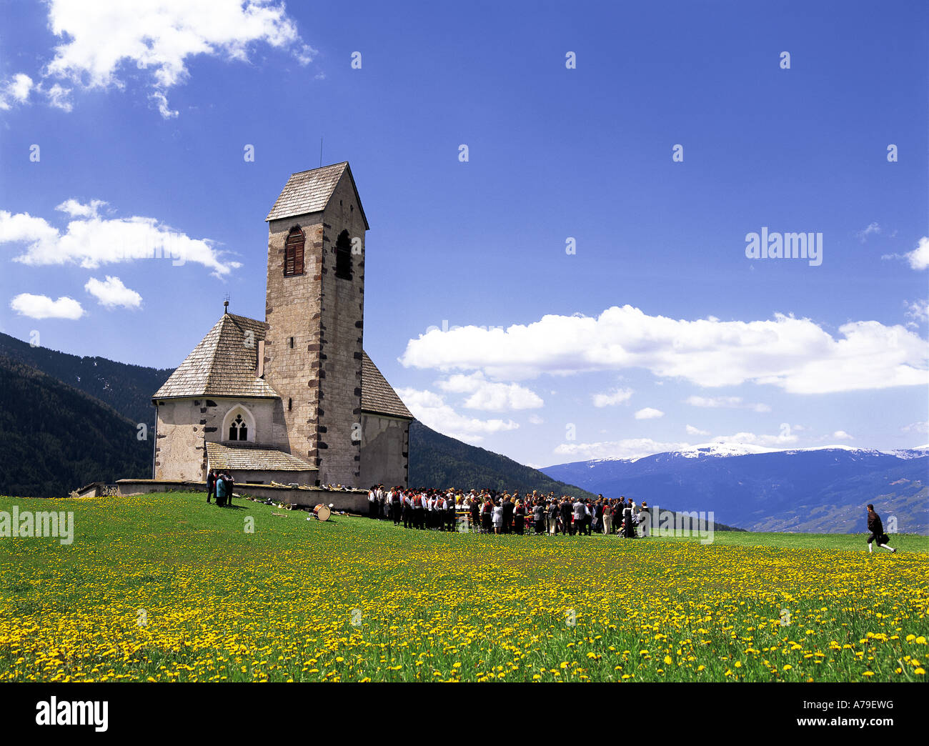 Wedding party outside St. Jacob church, Funes Valley, Villnoss, South Tirol, Italy Stock Photo