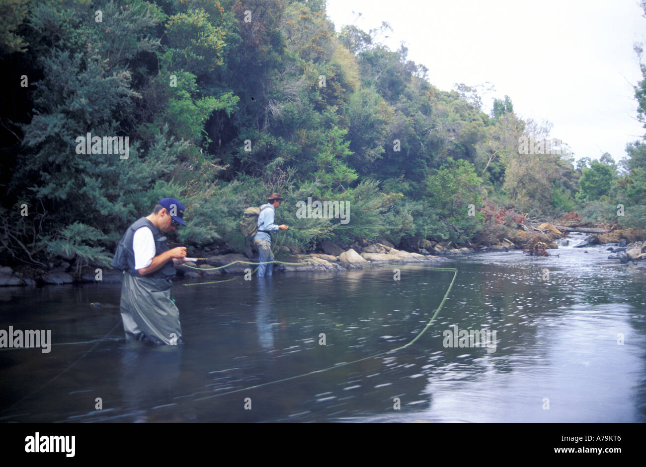 Trout fishermen with fly rods in the Tyenna River central Tasmania Australia Stock Photo