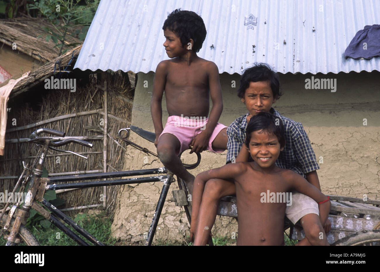 Indian children sitting on a bicycle, near Gaur, West Bengal, India Stock Photo