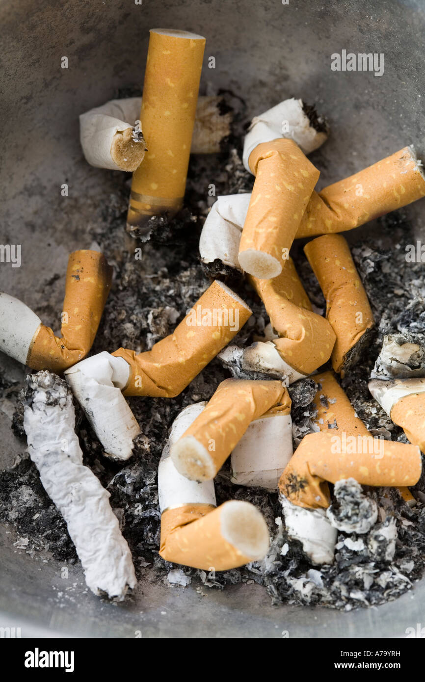 Smoked and half smoked cigarettes and ash in astray Stock Photo Alamy