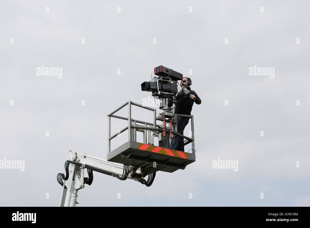 Television camera and cameraman on hydraulic platform Stock Photo