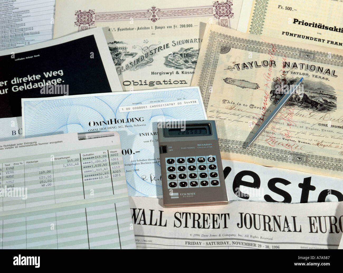 savings shares and bonds guidebook and newspaper name wall street journal europe calculator Stock Photo