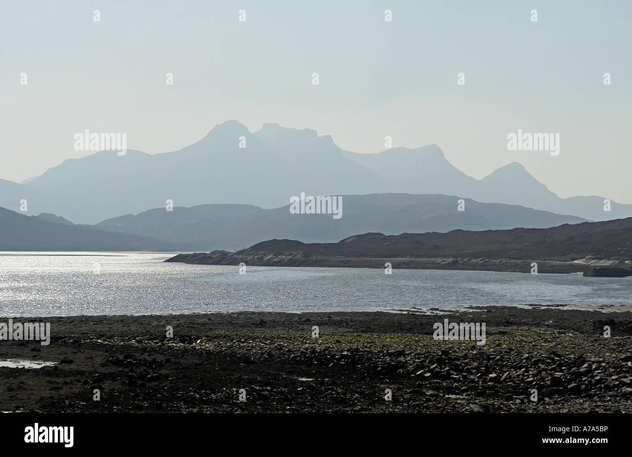 Ben Loyal in haze on a sunny spring day viewed from Achuvoldrach at causeway crossing Kyle of Tongue Sutherland Scotland Stock Photo