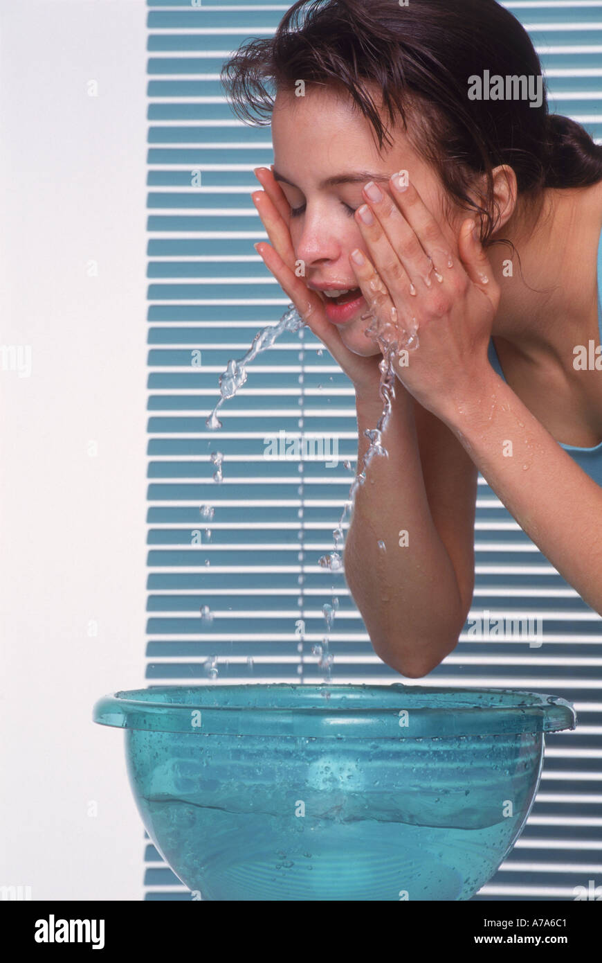 young woman refreshing her face Stock Photo