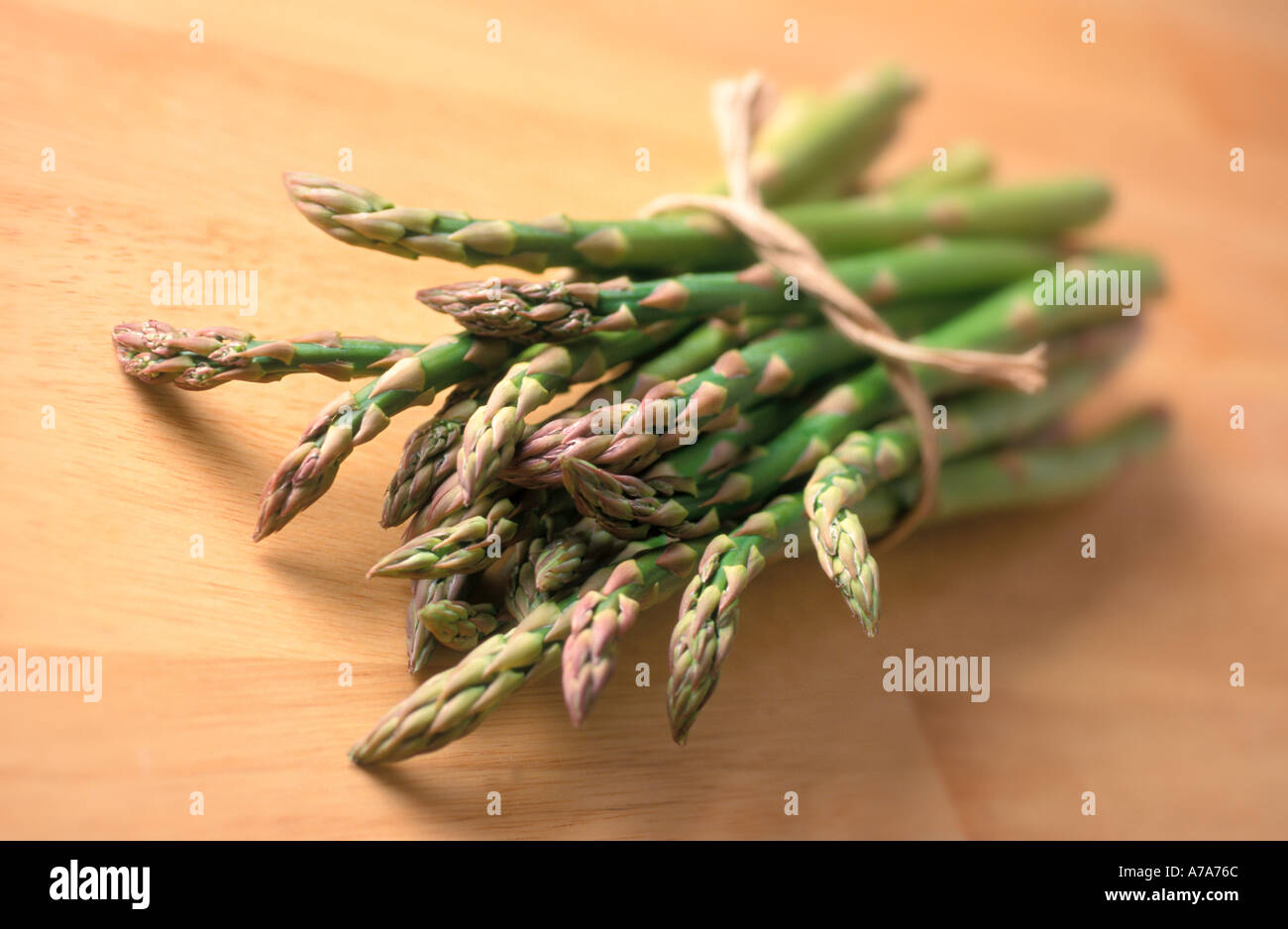 bunch of fresh asparagus on table Stock Photo