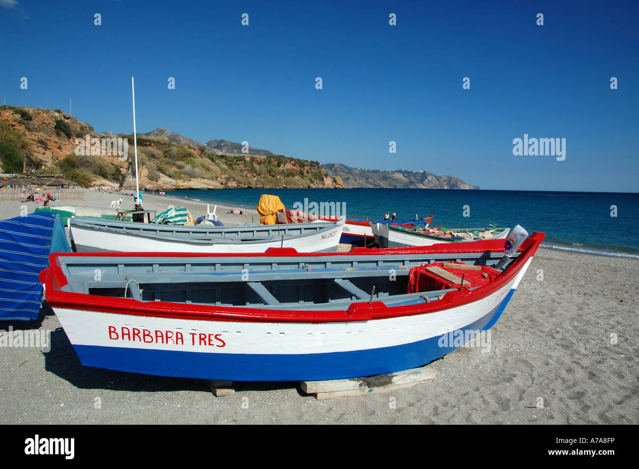 Brightly coloured fishing boat on Playa de Burriana, Nerja, Costa del Sol, Spain Stock Photo