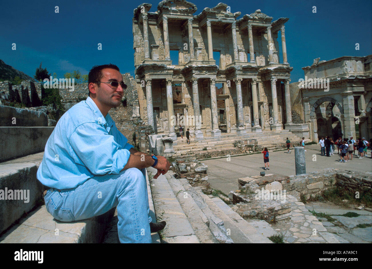 Asia Turkey Ephesus Antique Library Young Turkish man sitting in front of Antique Library Celsus Ephesos Stock Photo