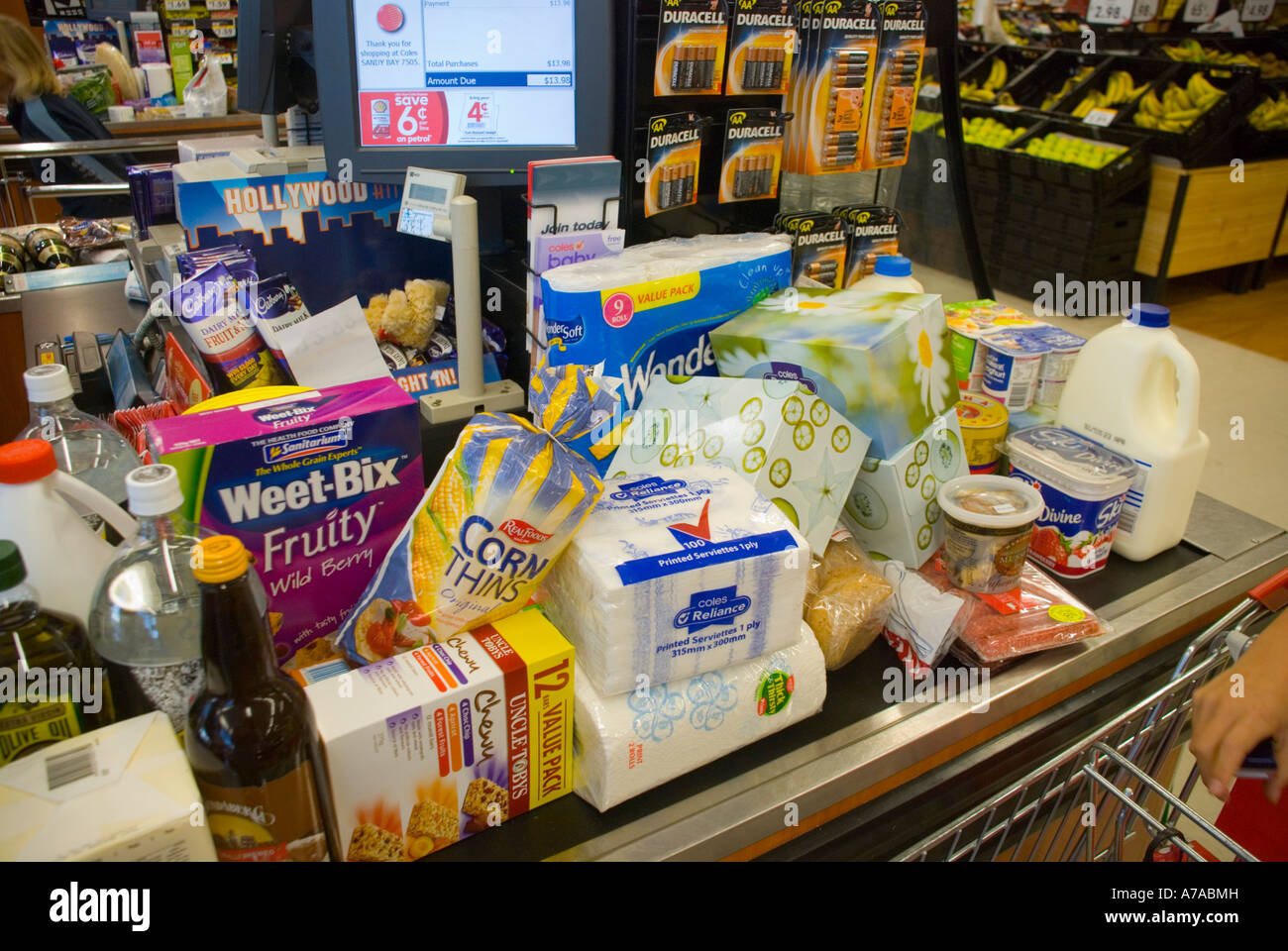 A family's weekly shopping piled up at a supermarket checkout Stock Photo