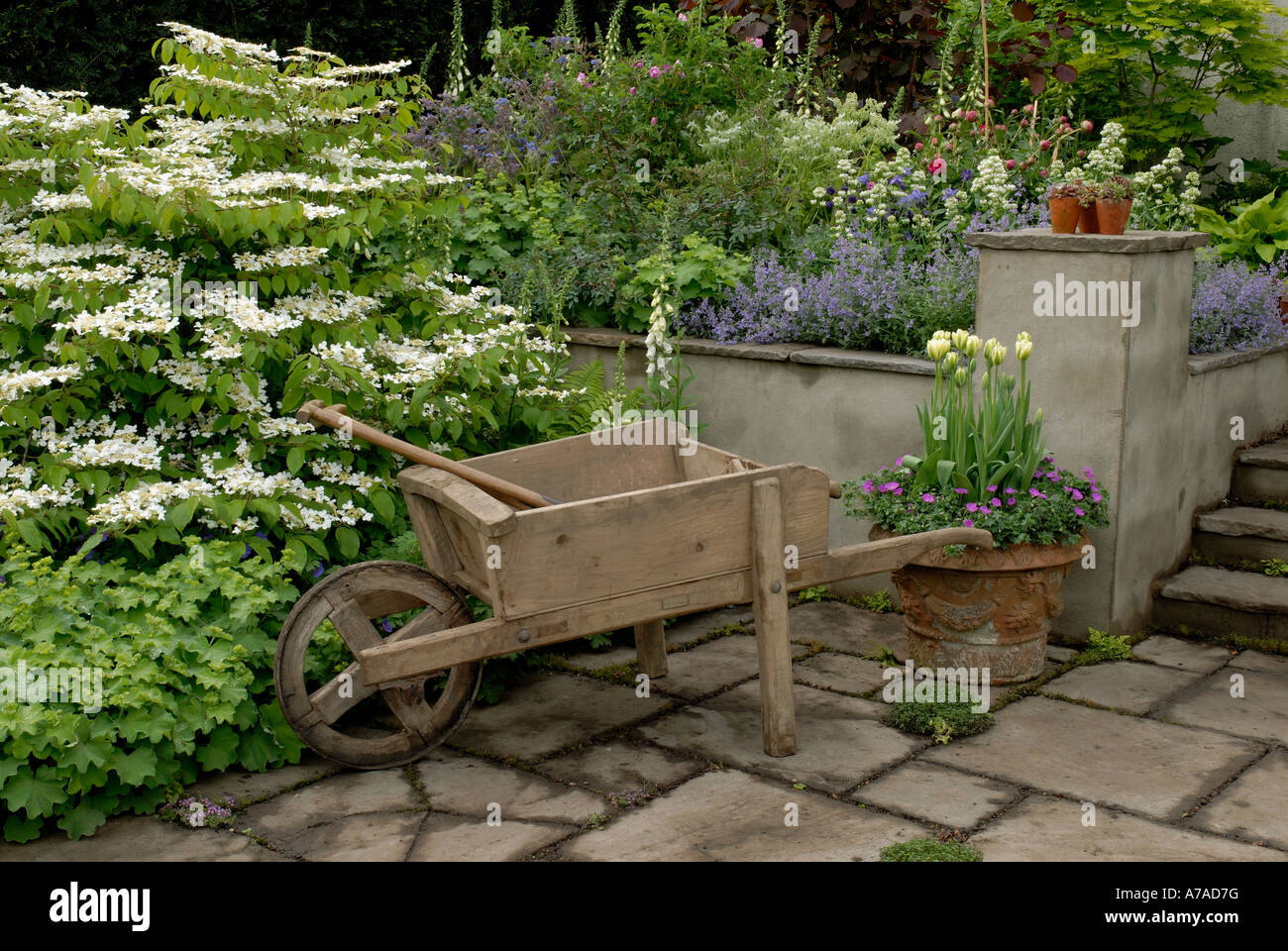 wheelbarrow in RHS Chelsea flower show 2006 design garden by Chris Beardshaw Stock Photo