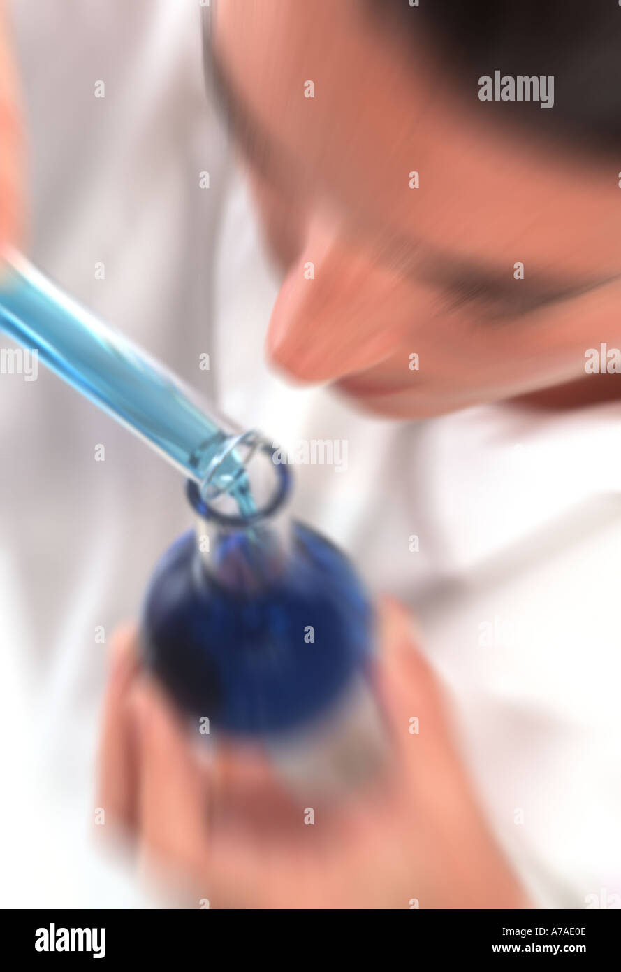 technician examining a beaker containing blue biological sample liquid Stock Photo