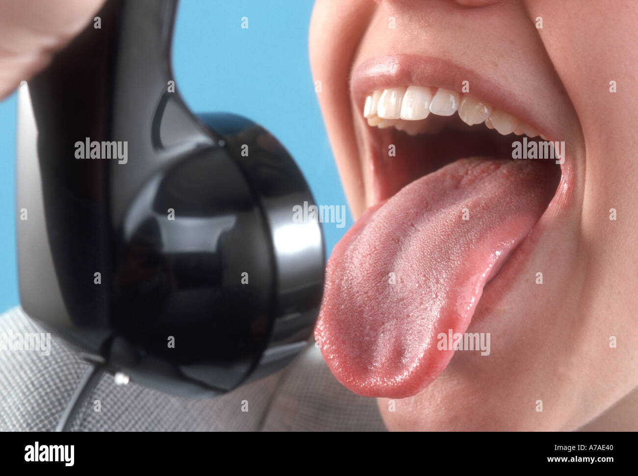 young woman yelling at telephone Stock Photo