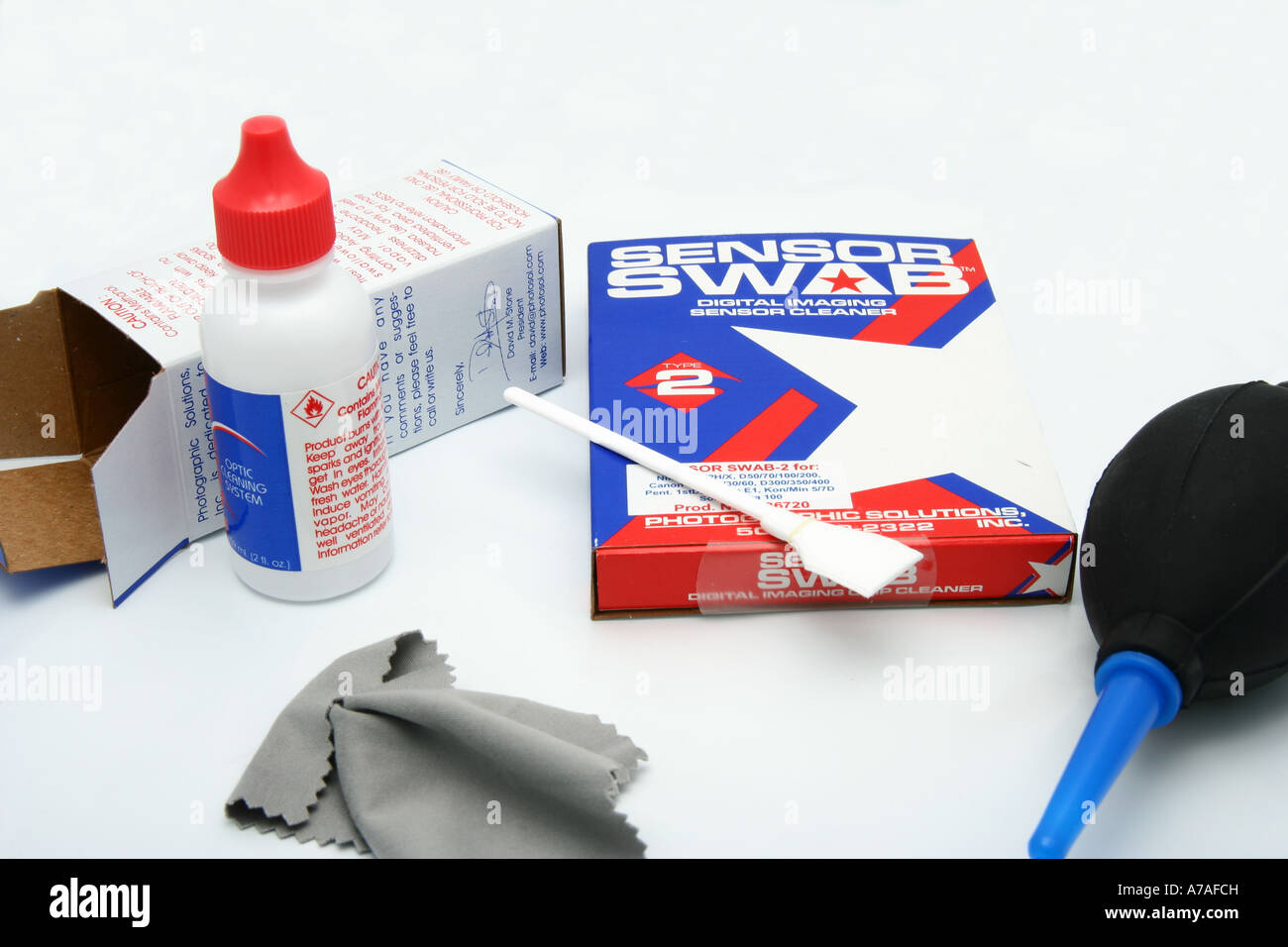 Liquids, pads, lens tissue and blower used for cleaning the sensor of a