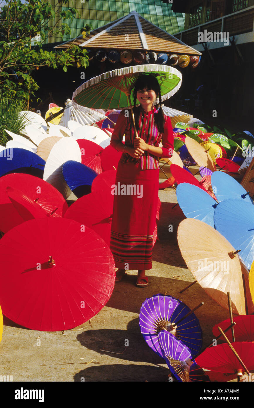 Thai woman surrounded by painted umbrellas in Chiang Mai Thailand Stock Photo