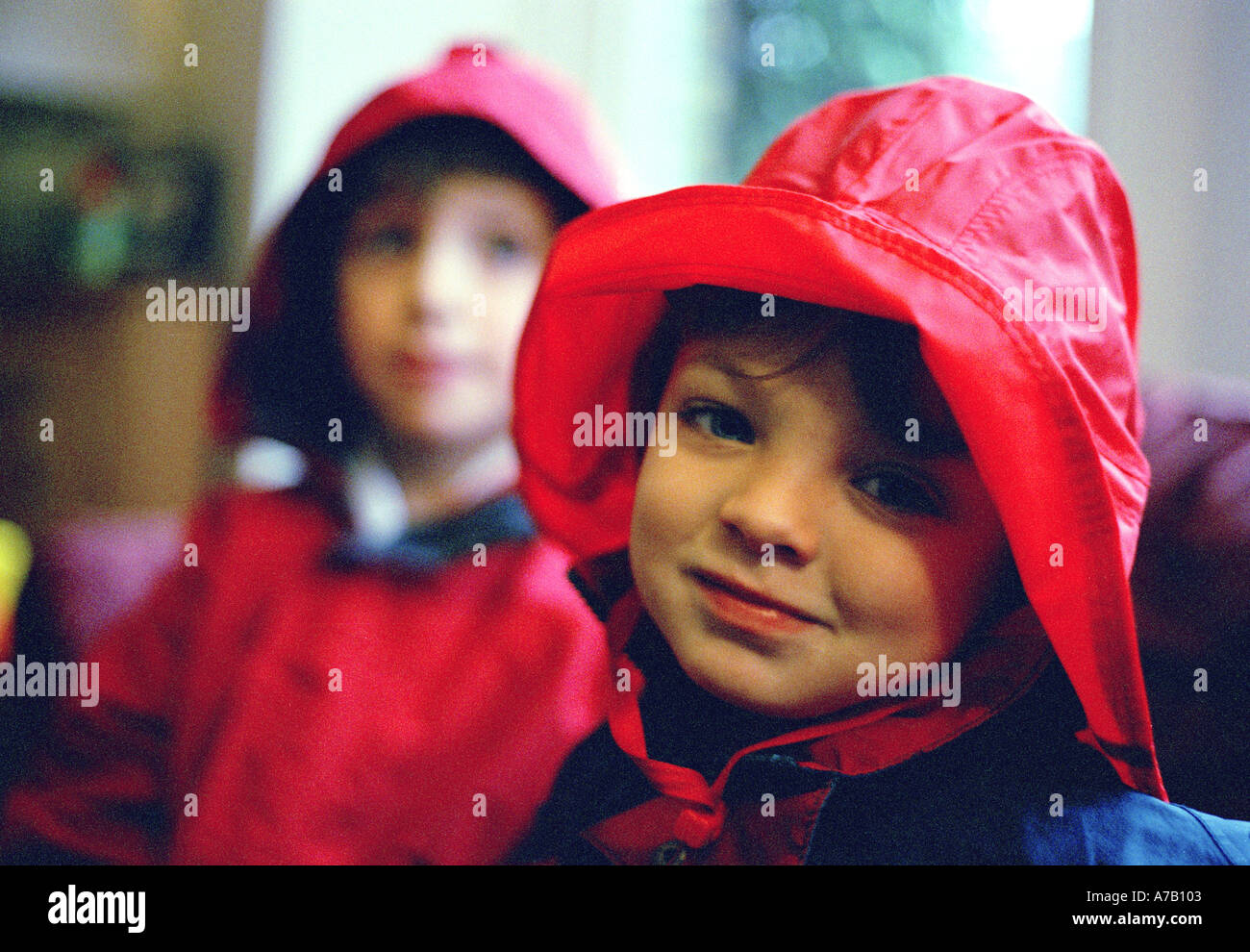 head shot of two boys dressed up in red fishing hats and overcoats