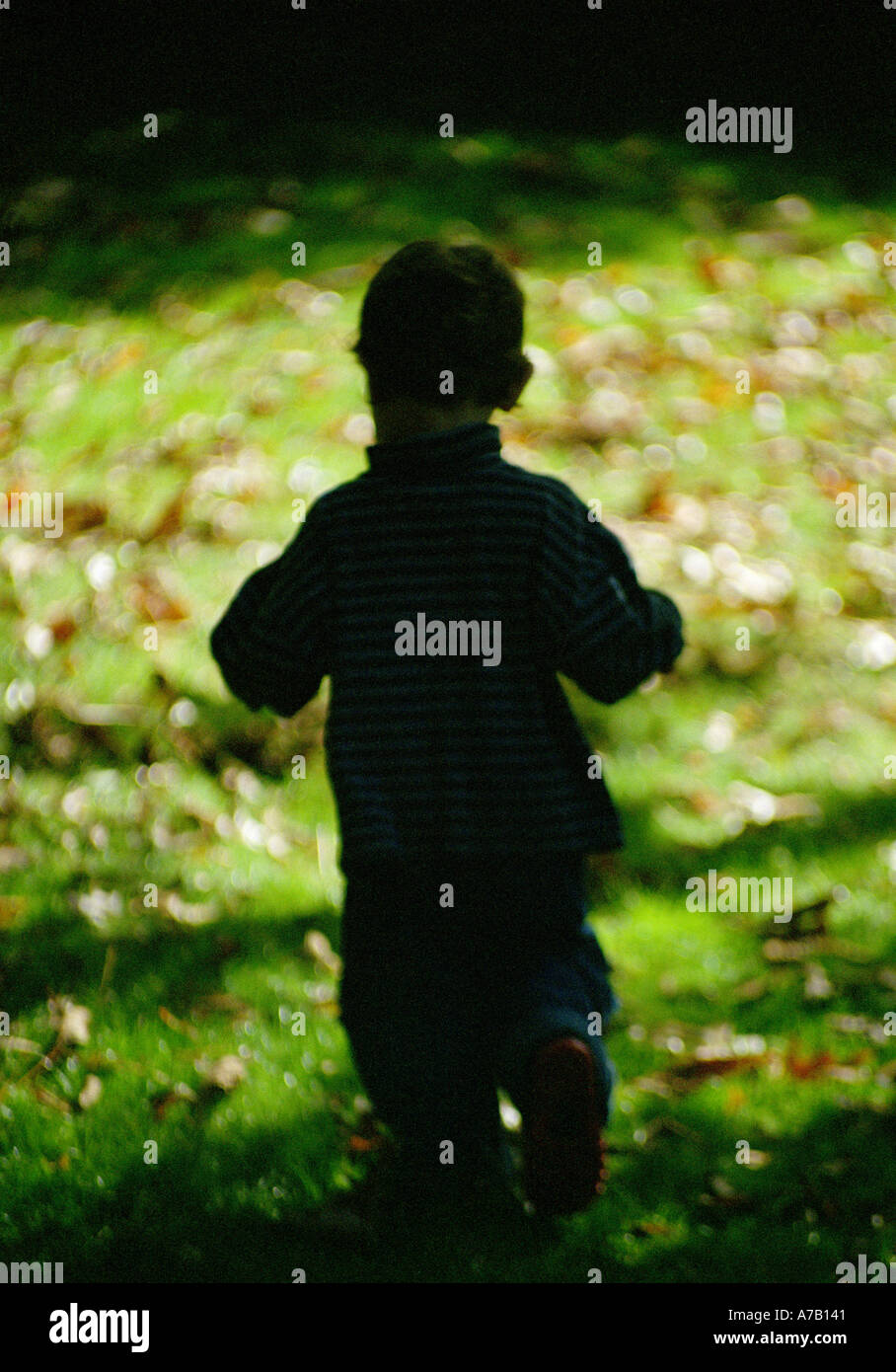 sillouette of a small child in a garden Stock Photo
