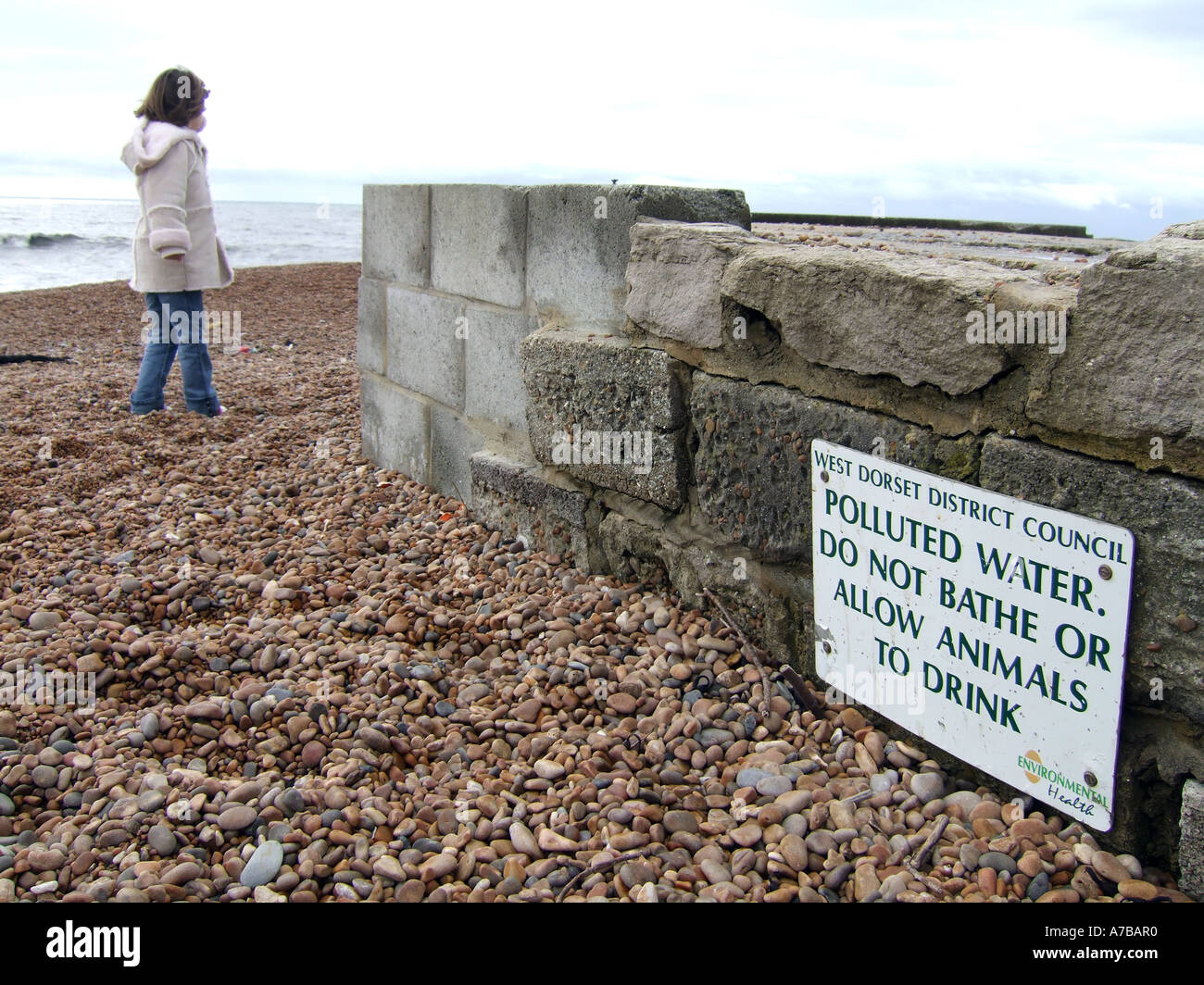 Polluted water warning sign at Seatown beach in Dorset Britain UK Stock