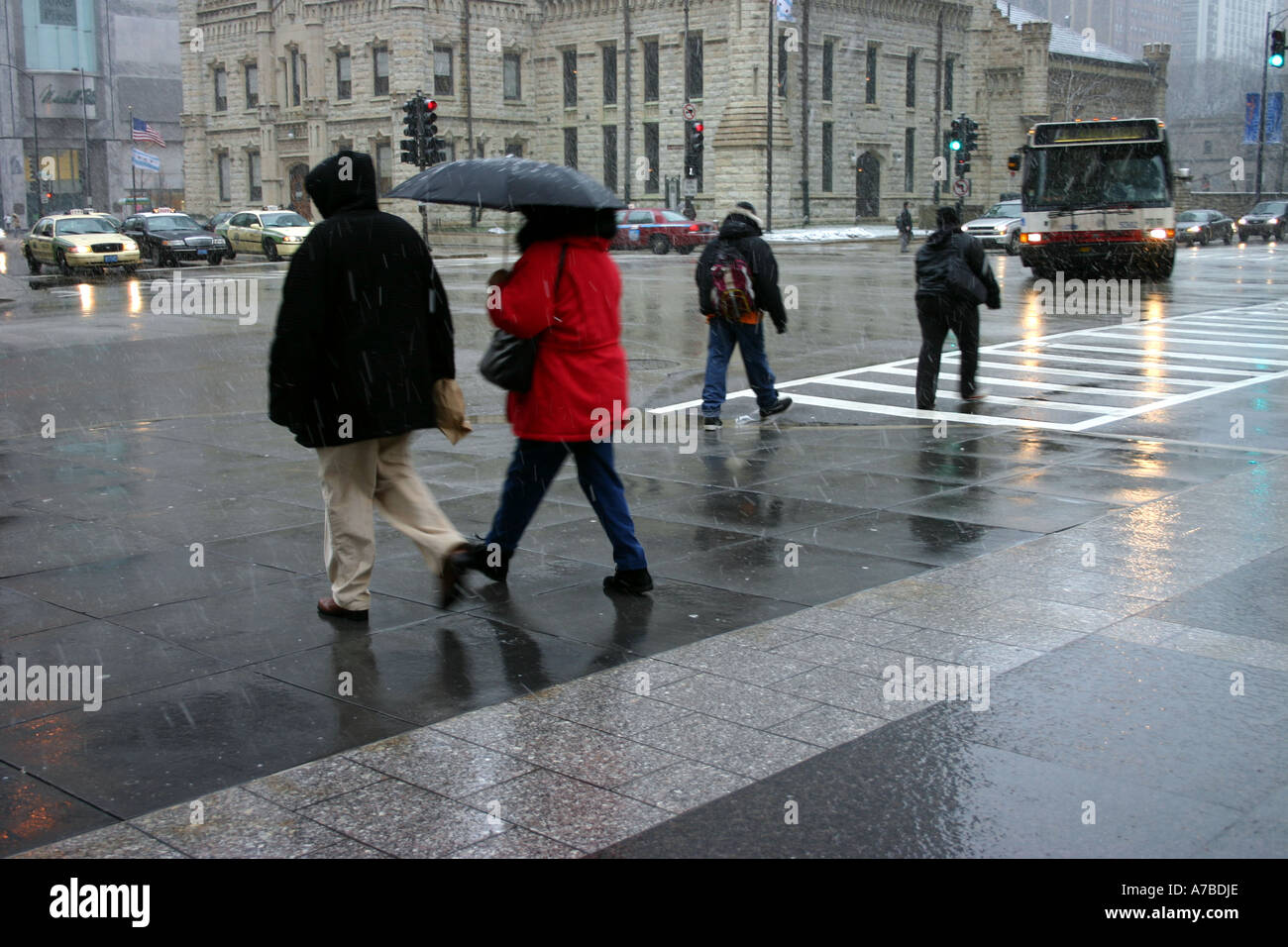people walking in a rain storm on Michigan Ave. downtown Chicago, IL Stock Photo