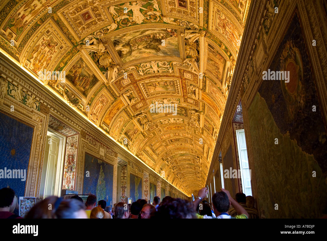 Ceiling of Vatican Museum gallery glows over heads of crowds of visitors Vatican City Rome Summer 2006 Stock Photo