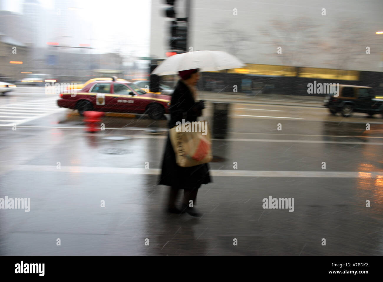 woman walking in a rain storm Stock Photo