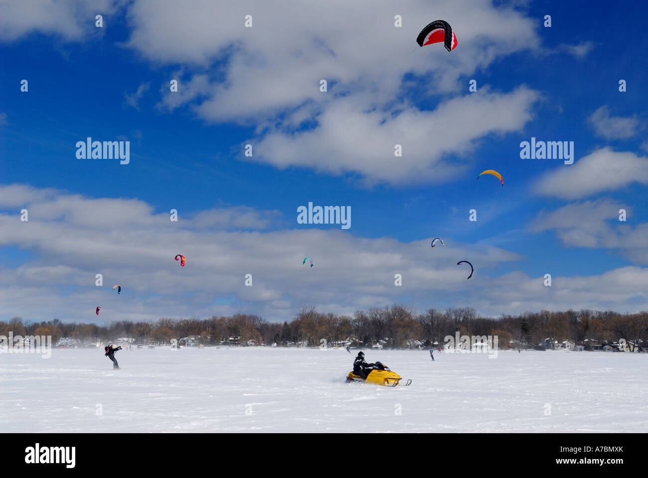 Foil kite windriders and snowmobile at Kitebeach Lake Simcoe Ontario Canada winter Stock Photo