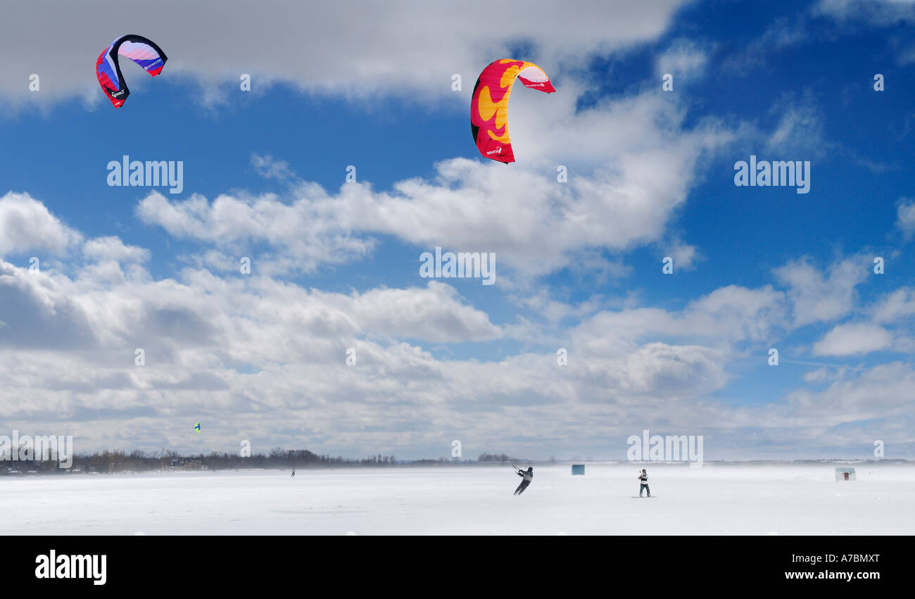 Boarder and skier snowkiting on frozen Lake Simcoe Ontario Canada Stock Photo