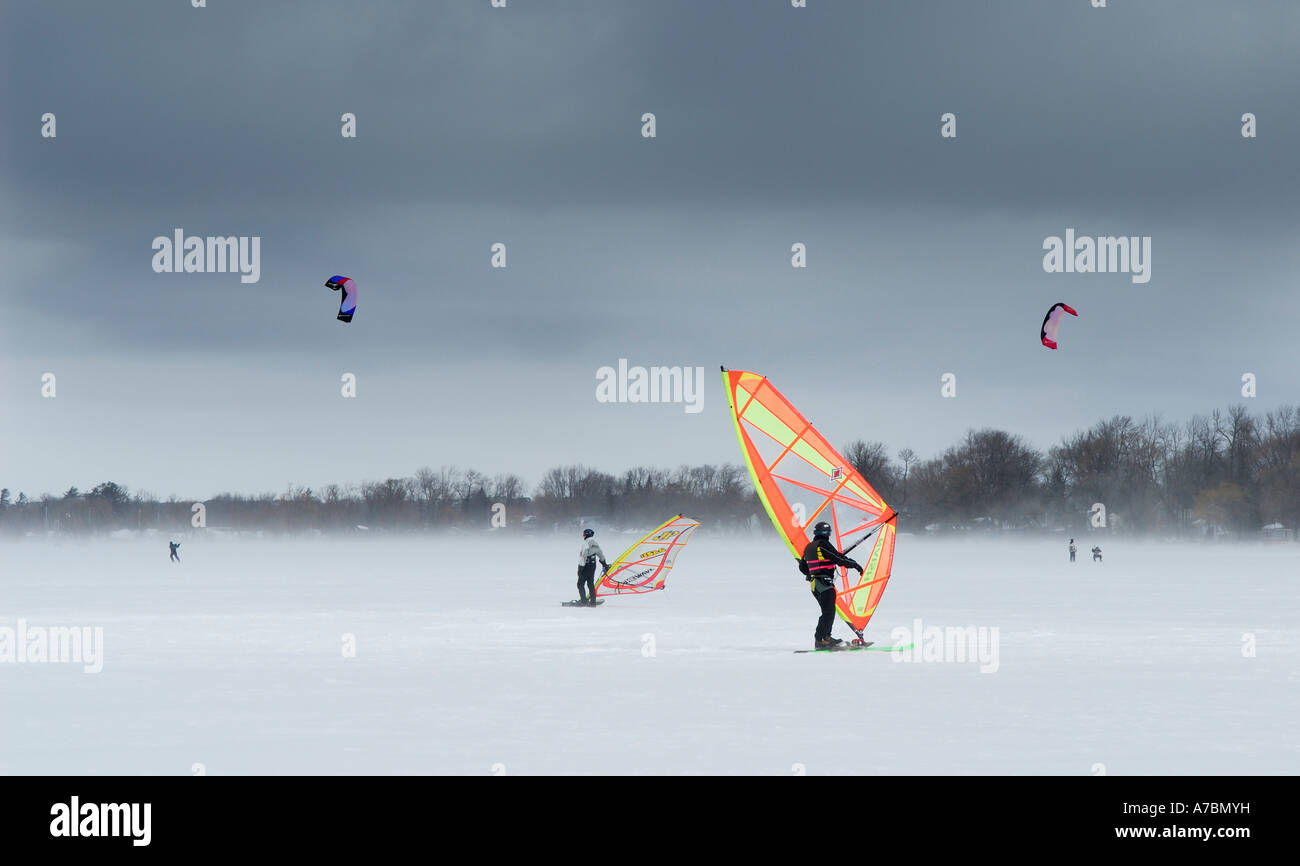 Wind surfers and snow kiters on frozen lake Simcoe Ontario Canada Stock Photo