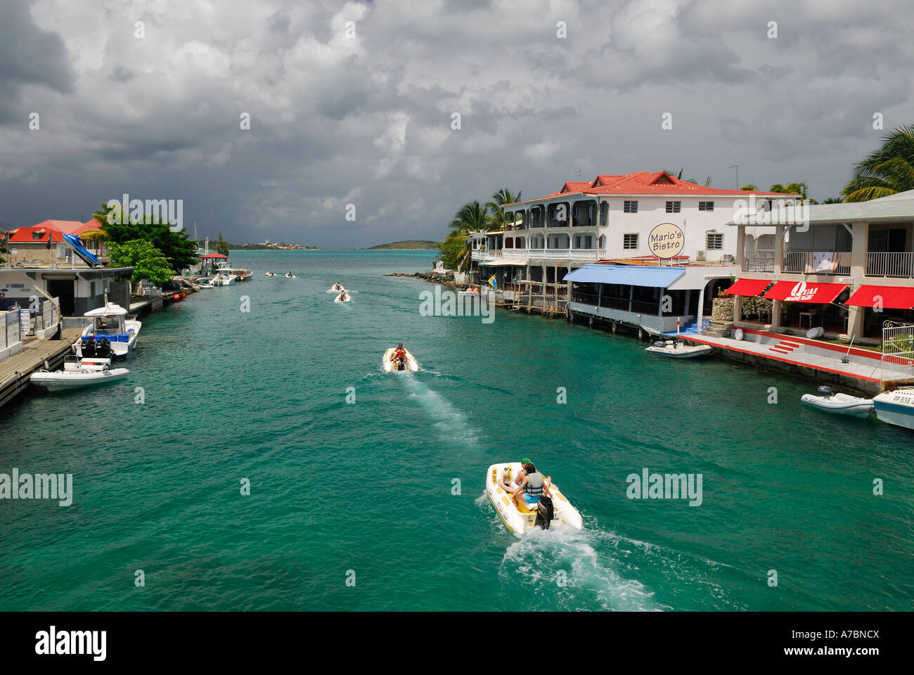 Line of boaters in water channel at Sandy Ground Bridge St Martin with storm clouds Stock Photo