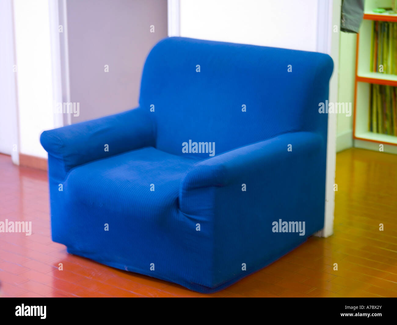 blue armchair, relax, confort, inside office, study, covered, close up, floor, brown tiles, white wall, library, books, soft Stock Photo