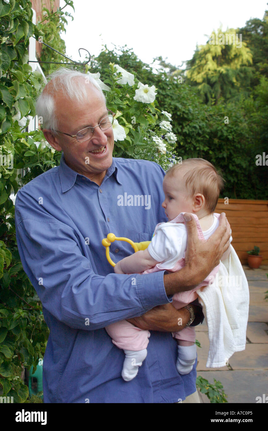 Grandfather holding granddaughter Stock Photo Alamy