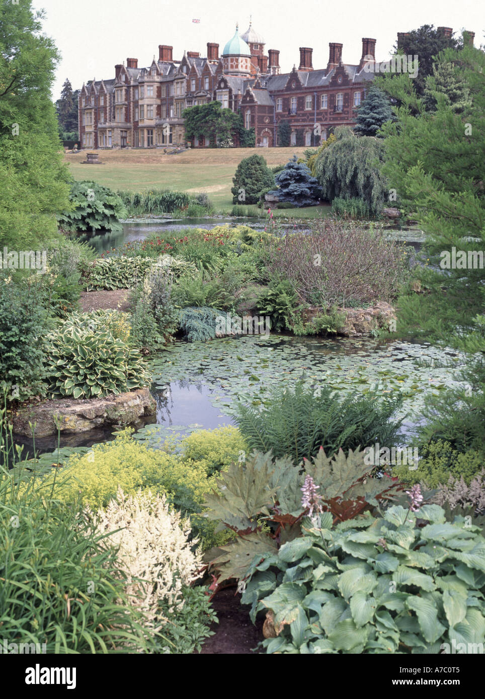 The rear elevation of The Royal Residence of Sandringham House and gardens with pond Stock Photo