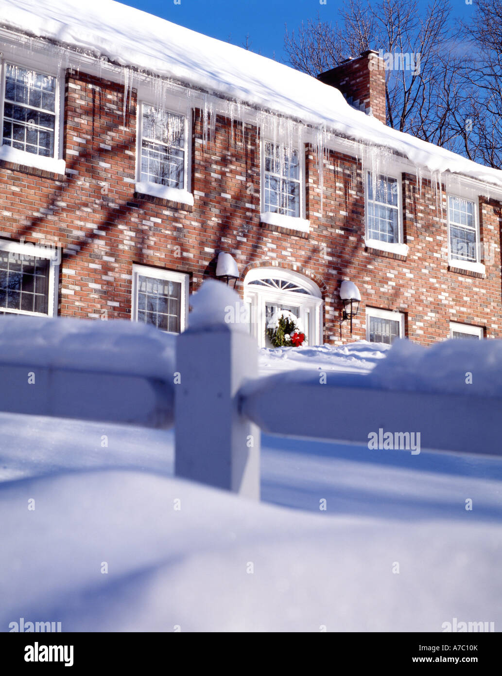 Brick house decorated for Christmas with evergreen wreath on door after ...