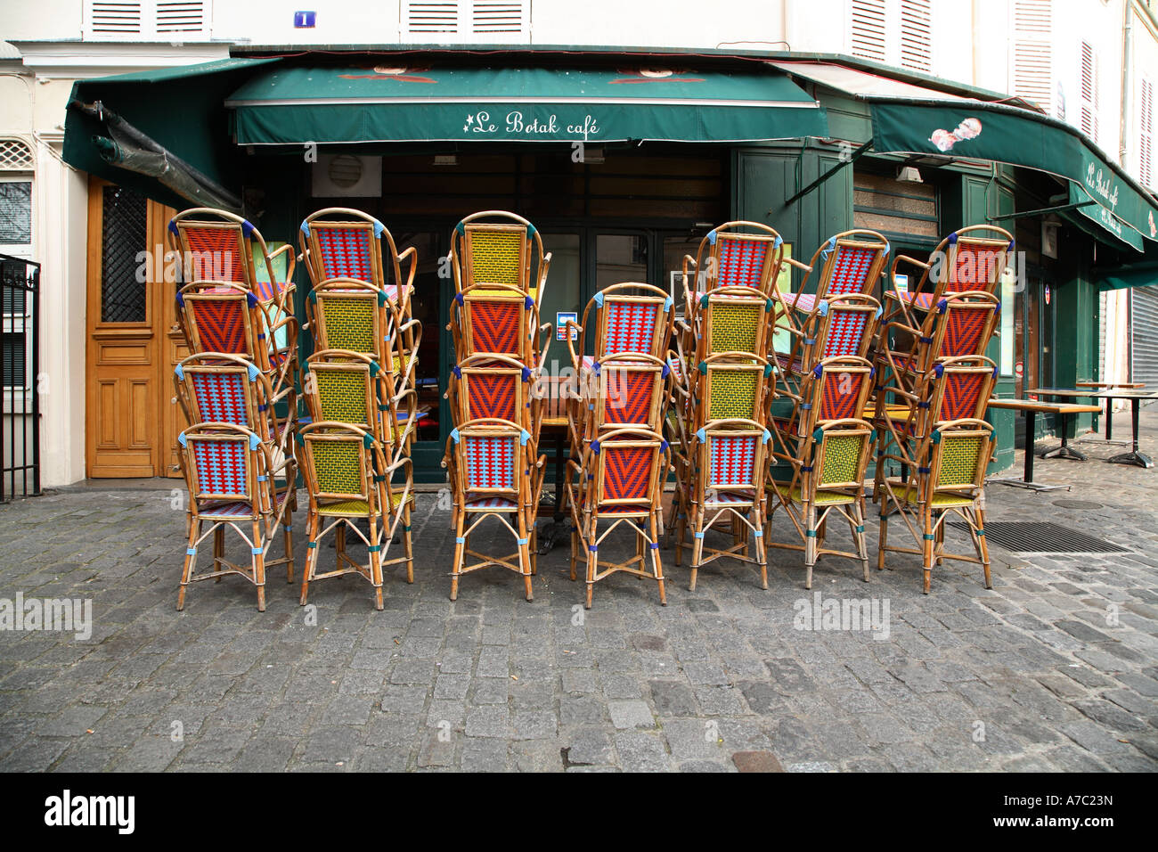 piled chairs in front of a brasserie of paris at montmartre france in the early morning, europe Stock Photo