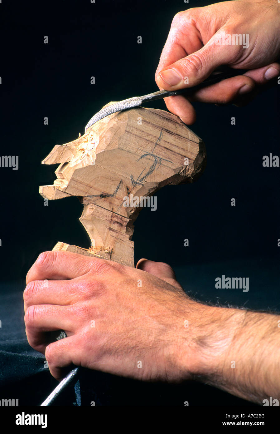 Puppet being carved from wood Stock Photo