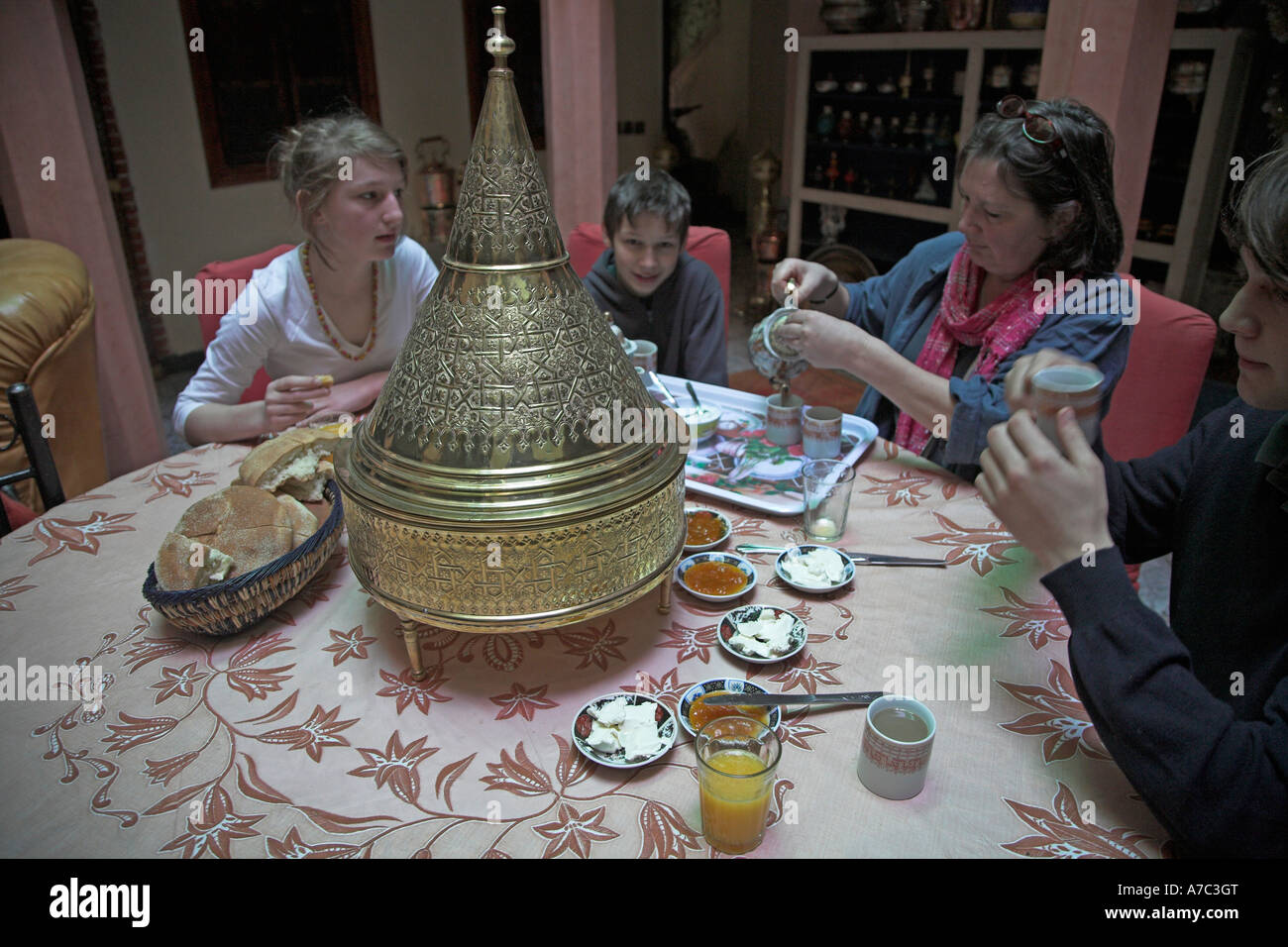 Family having breakfast in riad salon Marrakech, Morocco, Stock Photo