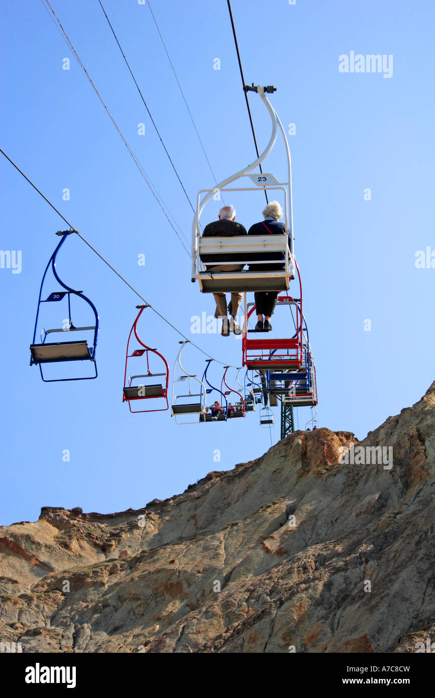Chairlift over cliffs set against clear blue sky Stock Photo - Alamy