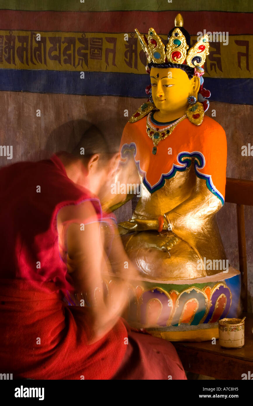 Young monk paiting a Buddha inside Thiksey Monastery Ladakh Indian Himalaya Stock Photo