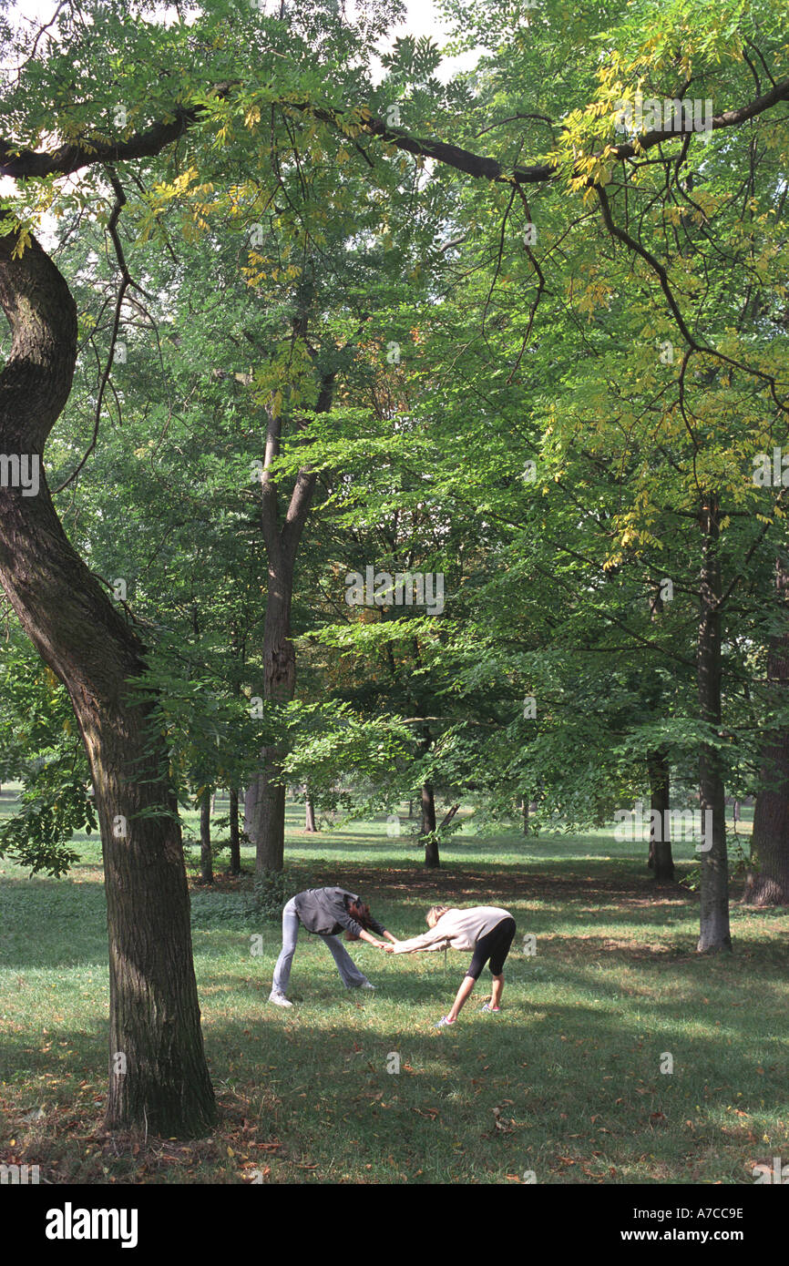 Two women stretching in park Stock Photo