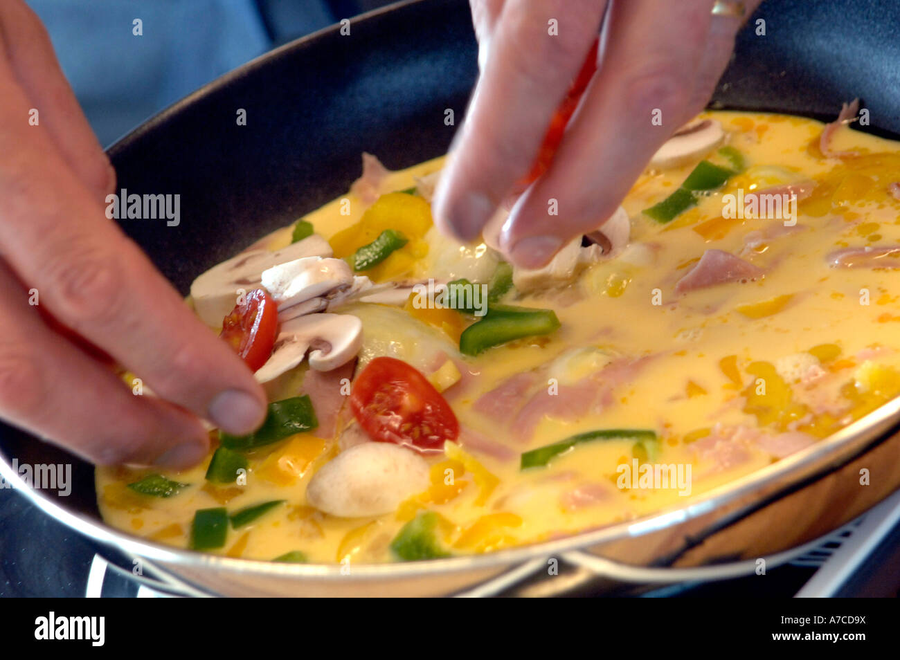 Making omelettes - folding over plain omelette using a large spatula Stock  Photo - Alamy