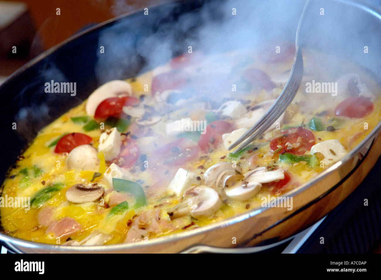 Making omelettes - folding over plain omelette using a large spatula Stock  Photo - Alamy