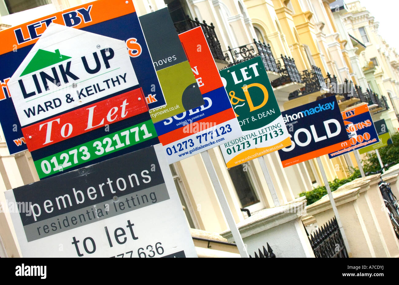 Estate agent for sale boards stacked up down a street. Picture by Jim Holden. Stock Photo