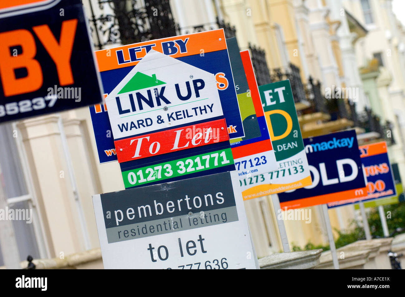 Estate agent for sale boards stacked up down a street. Picture by Jim Holden. Stock Photo