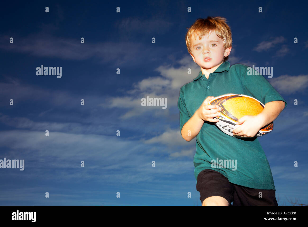 boy with rugby ball running Stock Photo Alamy