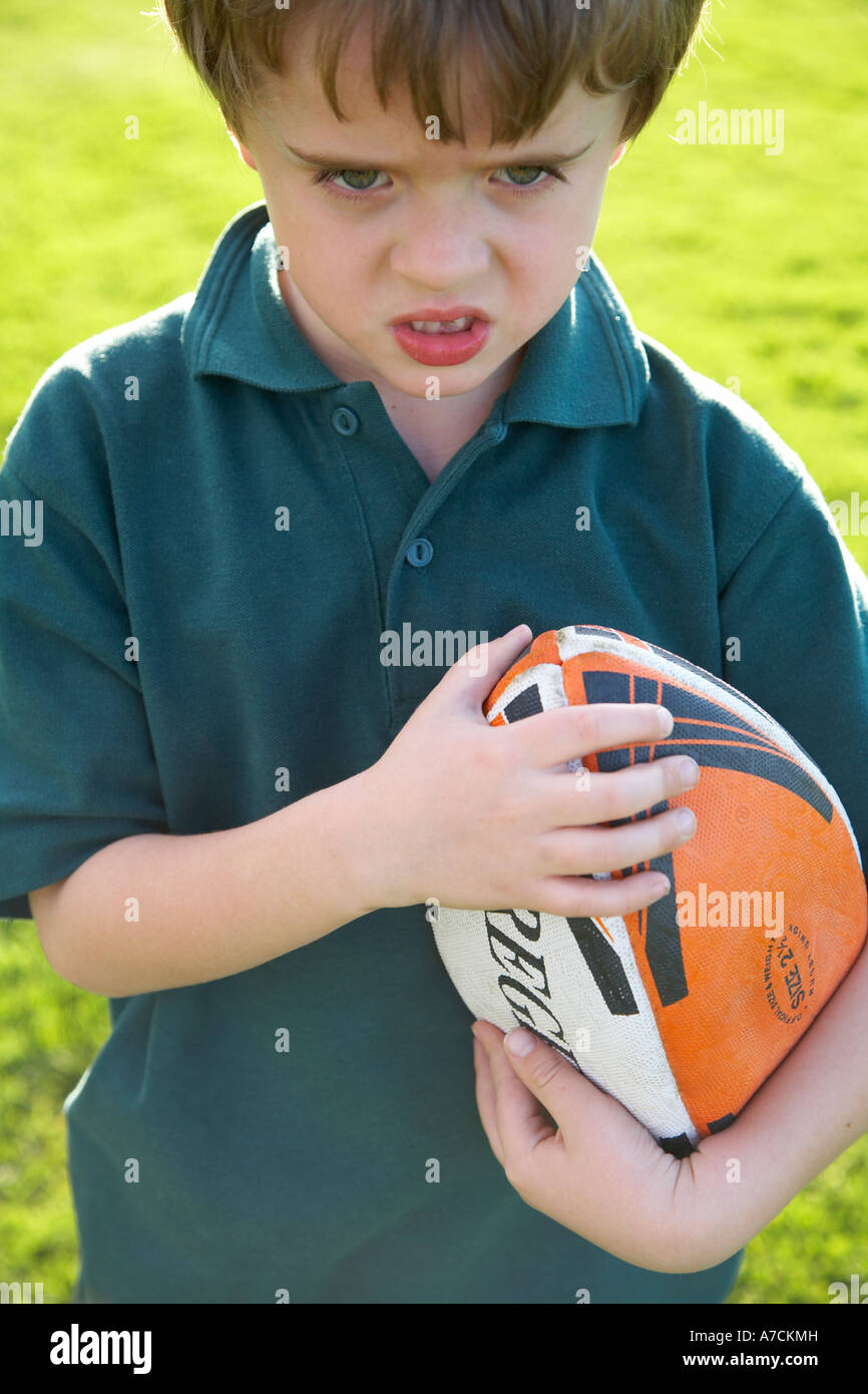 boy with rugby ball looking tough Stock Photo Alamy