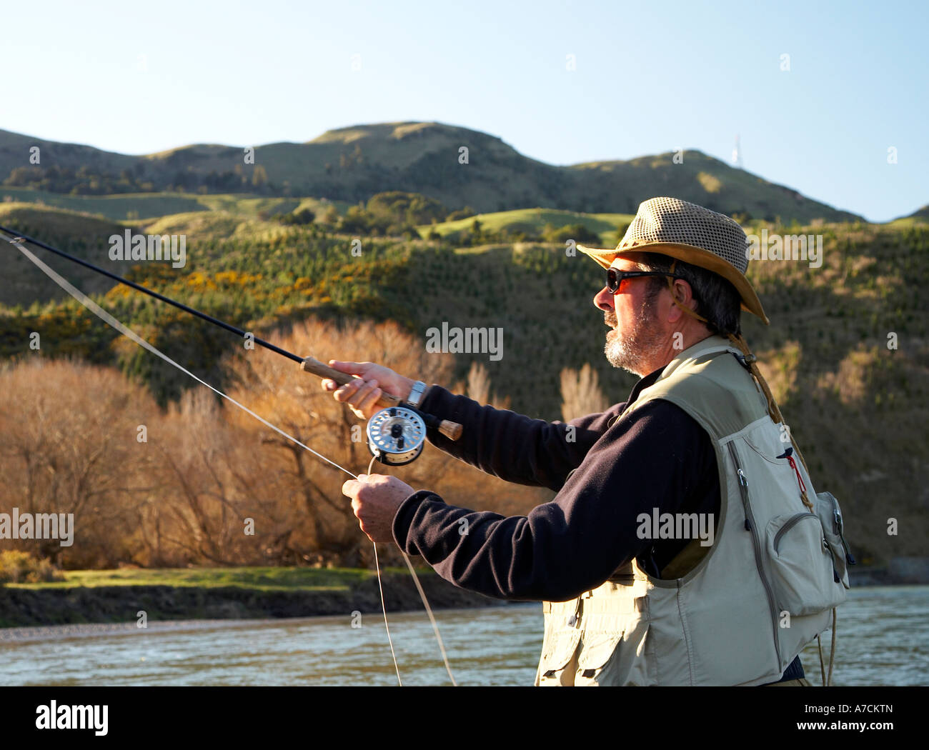man fly fishing casting hawkes bay new zealand Stock Photo