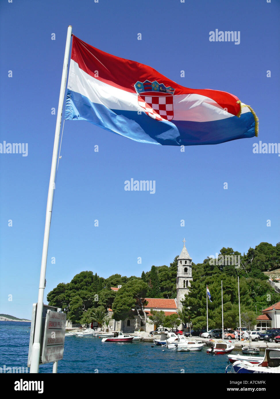 Croatian national flag flying by the sea at Cavtat a seaside resort south of Dubrovnik Croatia Balkans Europe EU Stock Photo