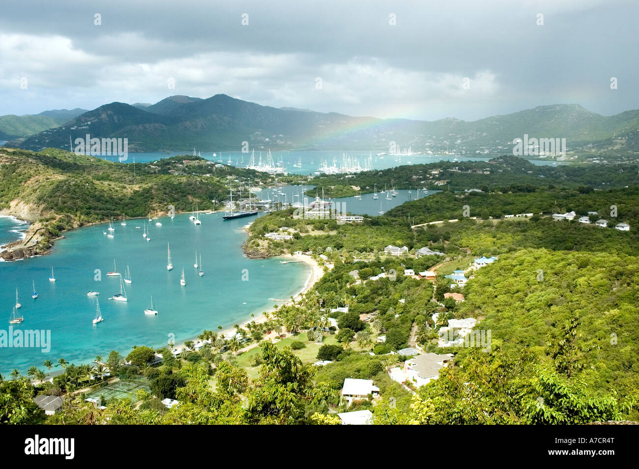 The calm blue waters of English Harbour dotted with white yachts as seen from The Lookout, Shirley Heights, Antigua Stock Photo