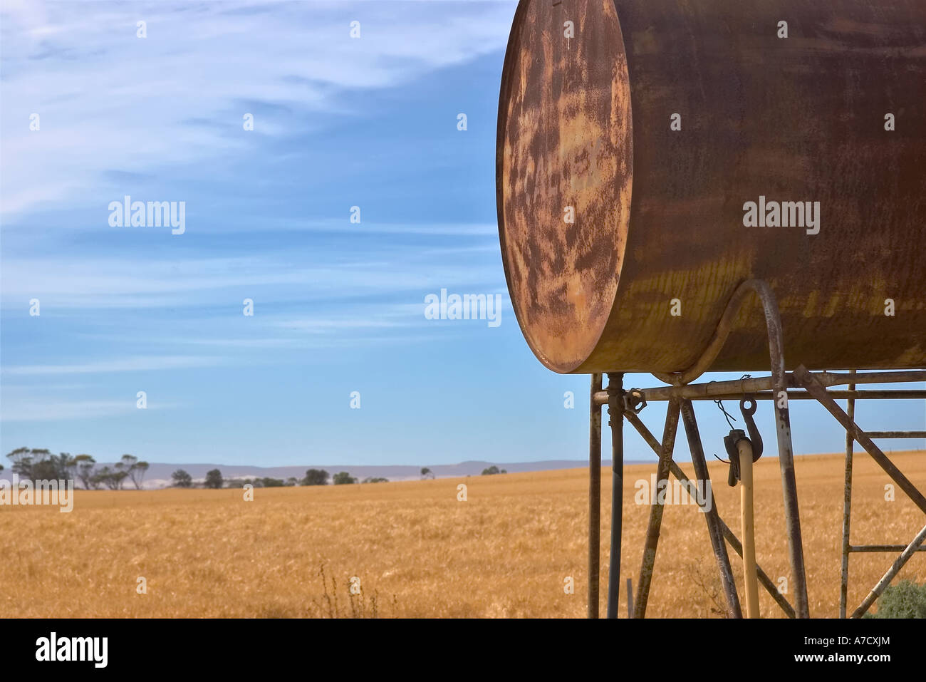 an old fuel tank and a field of wheat Stock Photo Alamy