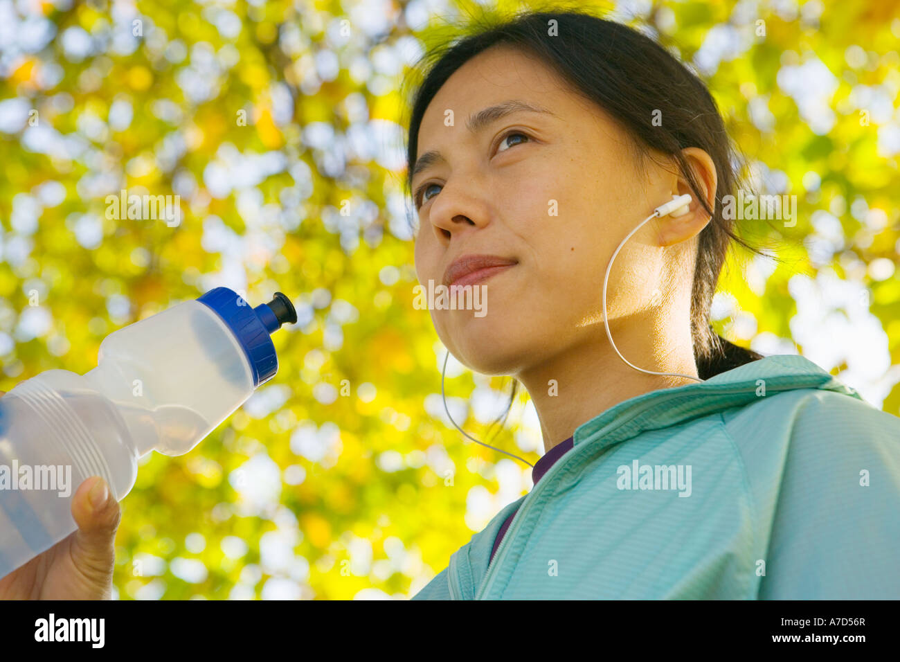 Young female with water bottle and MP3 player Stock Photo