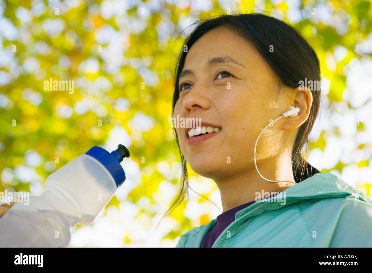 Young female with water bottle and MP3 player Stock Photo Alamy